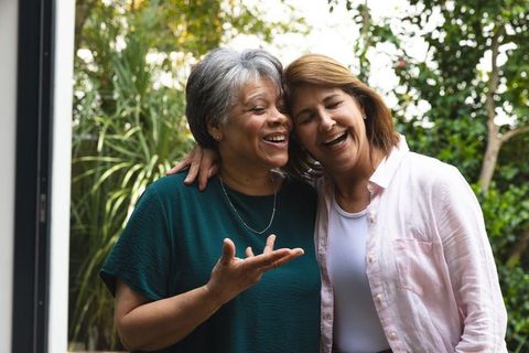 Elderly Mother and Daughter Laughing Together in Garden