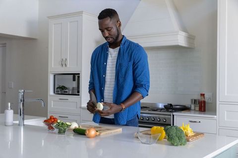 Man Cooking Healthy Meal in Modern Kitchen
