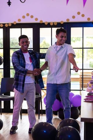 Friends celebrating with laughter and cake indoors