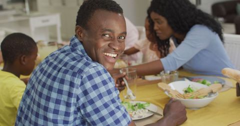 Happy Family Lunch Gathering with African American Father Enjoying Time