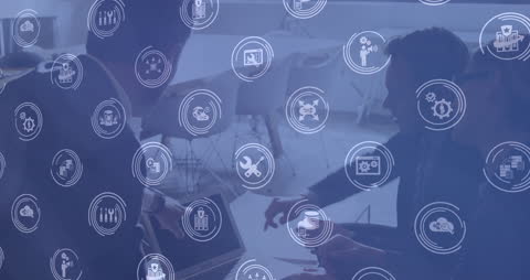 Collaborative Team Analyzing Technology Icons Overlay in Office