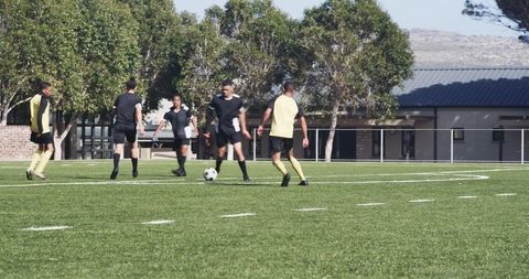 Teen Soccer Players Practicing on Green Field at Daytime