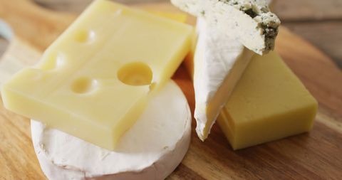 Assorted cheeses on wooden board for tasty snack ideas