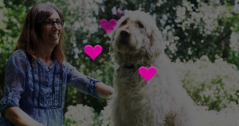 Woman enjoying park day with fluffy dog, radiating joy and companionship