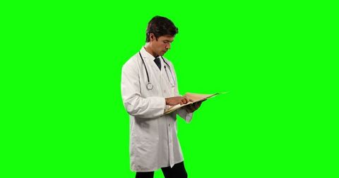 Doctor Reading Patient Report Stethoscope Around Neck