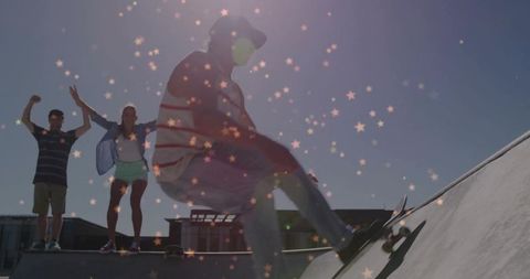 Skateboarder performing trick on ramp with friends cheering