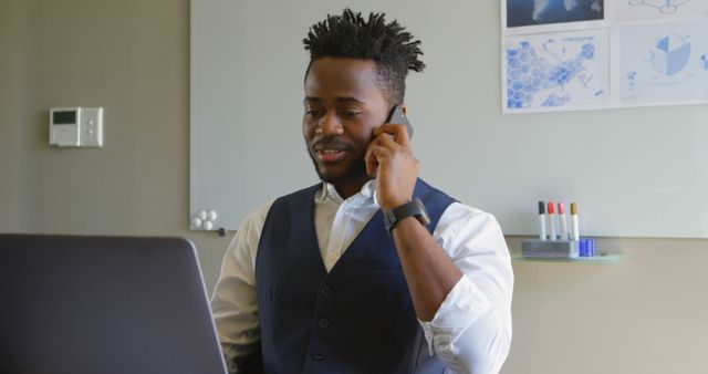 Confident African American Businessman Working on Laptop and Smartphone in Office - Download Free Stock Images Pikwizard.com