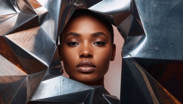 Futuristic beauty portrait framing model with reflective geometric metal aperture