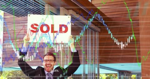 Triumphant businessman celebrating sales success in stock market