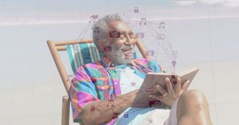 Senior man reading book by beach with digital interface overlay