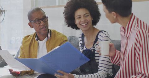 Diverse Team Collaborating Over Business Documents in Office