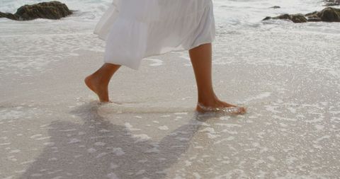 Woman Walking Barefoot at Coastline with Sea Foam - Download Free Stock Images Pikwizard.com