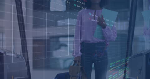 Businesswoman with Financial Graphs Overlay in Office Hallway
