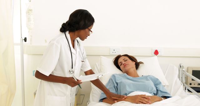 Female doctor monitoring patient's condition in hospital room. Doctor wearing white coat and stethoscope, holding clipboard while interacting with female patient lying in hospital bed. Good for use in healthcare, medicine, recovery, and patient care concepts.