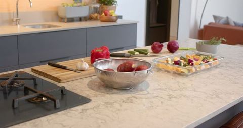 Modern Kitchen with Marble Island and Fresh Vegetables