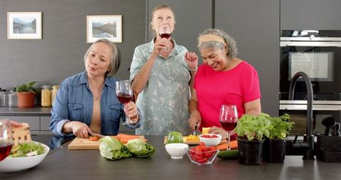Senior Women Socializing over Cooking and Wine