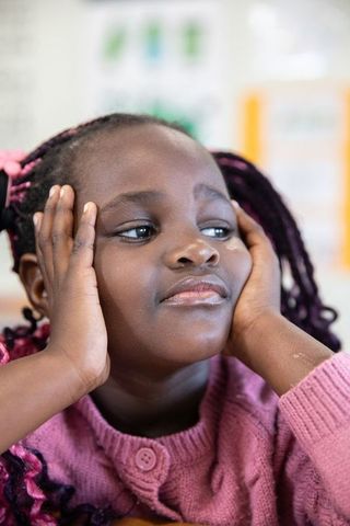Young Girl Contemplating Thoughts in Educational Classroom