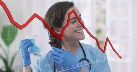 Smiling healthcare professional with downward economic graph