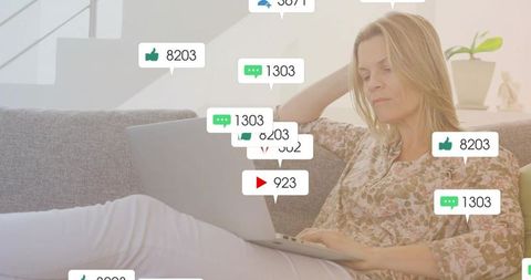 Woman relaxing on sofa analyzing laptop social media engagement