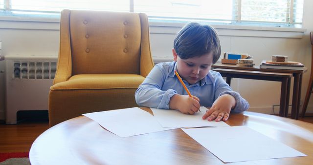 Young Child Writing on Paper at Home - Download Free Stock Images Pikwizard.com