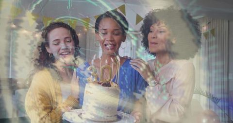 Friends celebrating 30th birthday home party with layer cake, gold 30 candles, balloons