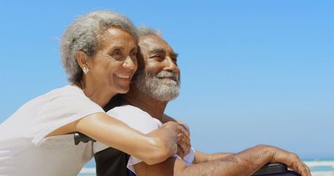 Happy Senior Couple Relaxing on Beach with Wheelchair - Download Free Stock Images Pikwizard.com