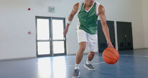 Young Athlete Dribbling Basketball in Indoor Court - Download Free Stock Images Pikwizard.com