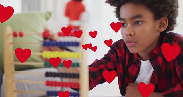 Young boy learning with abacus surrounded by hearts - Download Free Stock Images Pikwizard.com