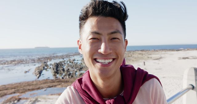 Smiling Young Man by Ocean with Clear Blue Sky - Download Free Stock Images Pikwizard.com