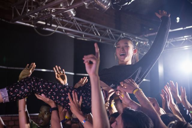 Crowd surfing at a concert in nightclub