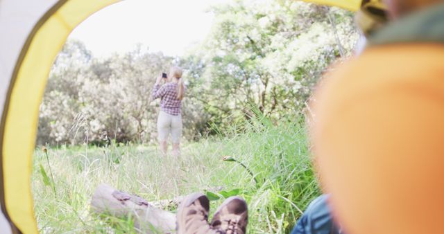 Relaxing in a Tent with View of Woman Exploring Nature - Download Free Stock Images Pikwizard.com