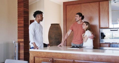Friends Engaged in Conversation in Modern Kitchen