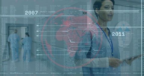 Doctor Monitoring Medical Data on Tablet in Hospital Corridor