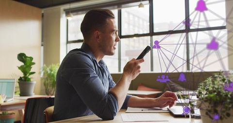 Young Professional Using Smartphone for Modern Communication in Office