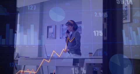 Businesswoman in Office Amid Financial Data and Graphs