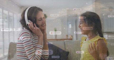 Mother and daughter sharing headphones and laughter on couch with social media badges overlay