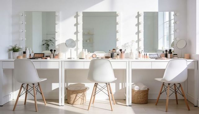 Sunlit scandinavian makeup vanity with three lighted mirrors, white chairs, minimalist organization