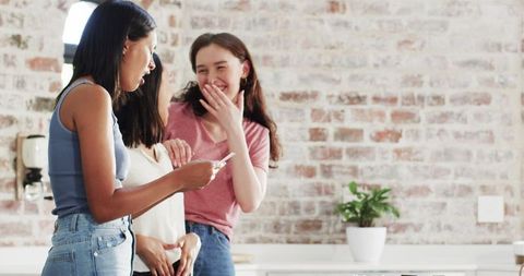 Women Celebrating Pregnancy News in Bright Kitchen Gathering