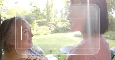 Smiling older and younger woman sharing warm moment on patio with cost estimates hud