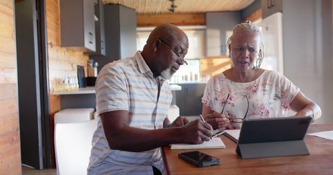 Senior Couple Managing Finances at Home Using Technology