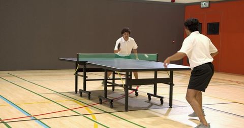 Intense Table Tennis Rally in Indoor Sports Hall