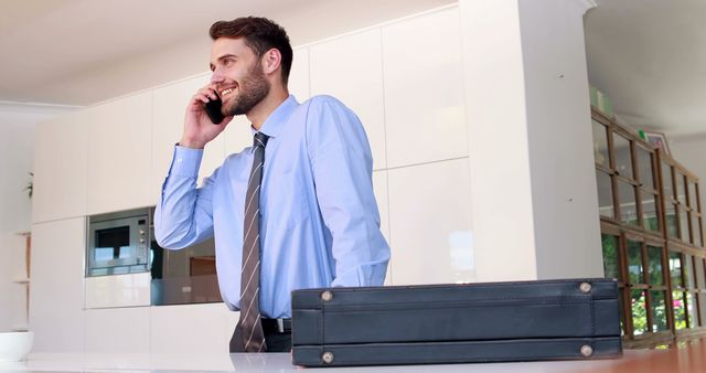 Business Professional Talking on Phone at Desk with Briefcase in Office - Download Free Stock Images Pikwizard.com