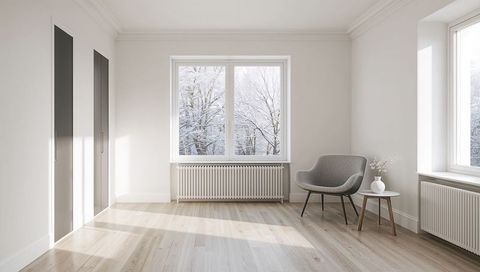Bright Minimal Scandinavian Living Room with Grey Armchair, Side Table and Winter View