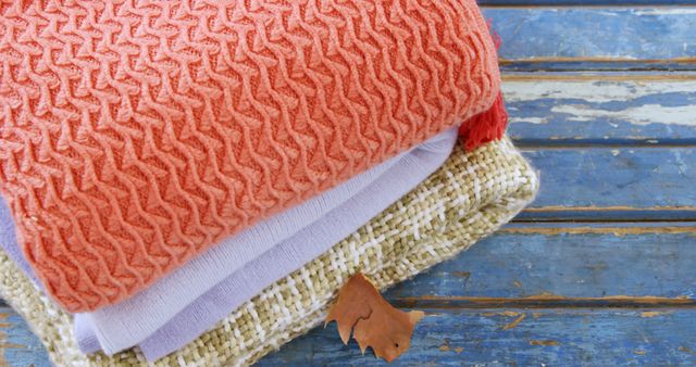 Folded Knit and Woolen Blankets on Weathered Wooden Surface in Autumn - Download Free Stock Images Pikwizard.com