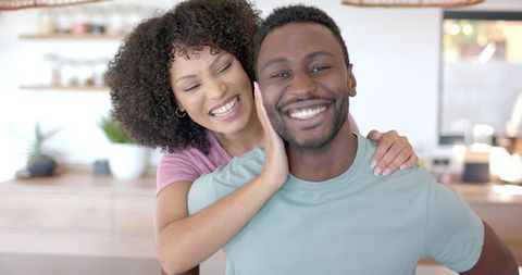 Happy Couple Laughing in Bright Kitchen