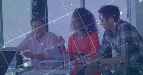 Business Colleagues Analyzing Data on Digital Devices in Modern Office