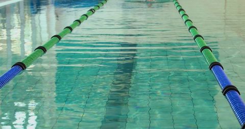 Serene indoor pool lane with divider reflections