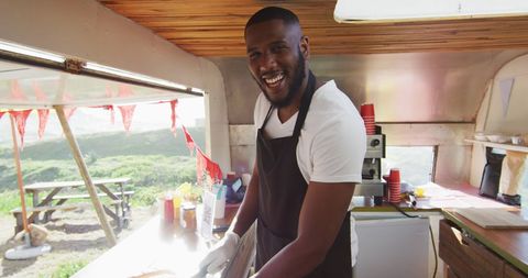 Smiling Chef Inside Food Truck Preparing Street Food - Download Free Stock Images Pikwizard.com