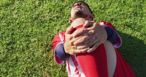 Injured Soccer Player Holding Knee on Field - Download Free Stock Images Pikwizard.com