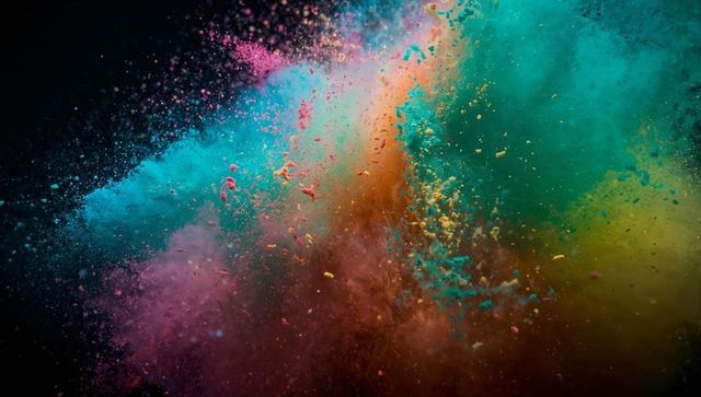 Dynamic explosion of vibrant colored powder in dark studio